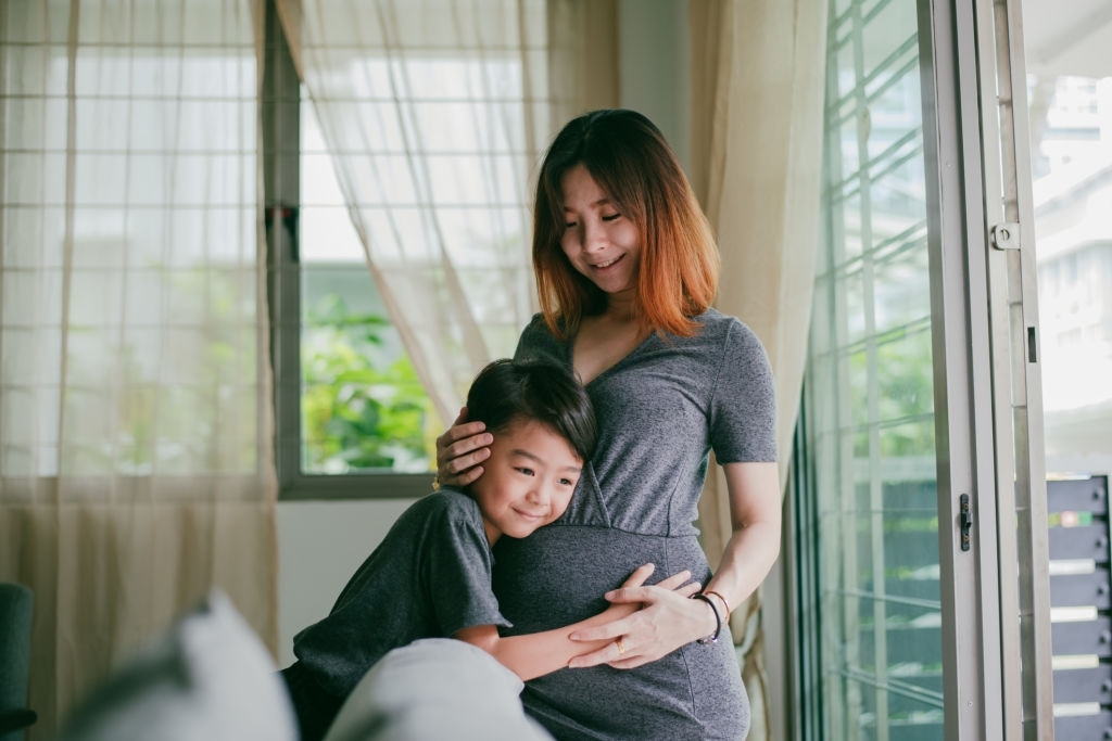 Asian beautiful pregnant woman enjoy her pregnancy with her son at home